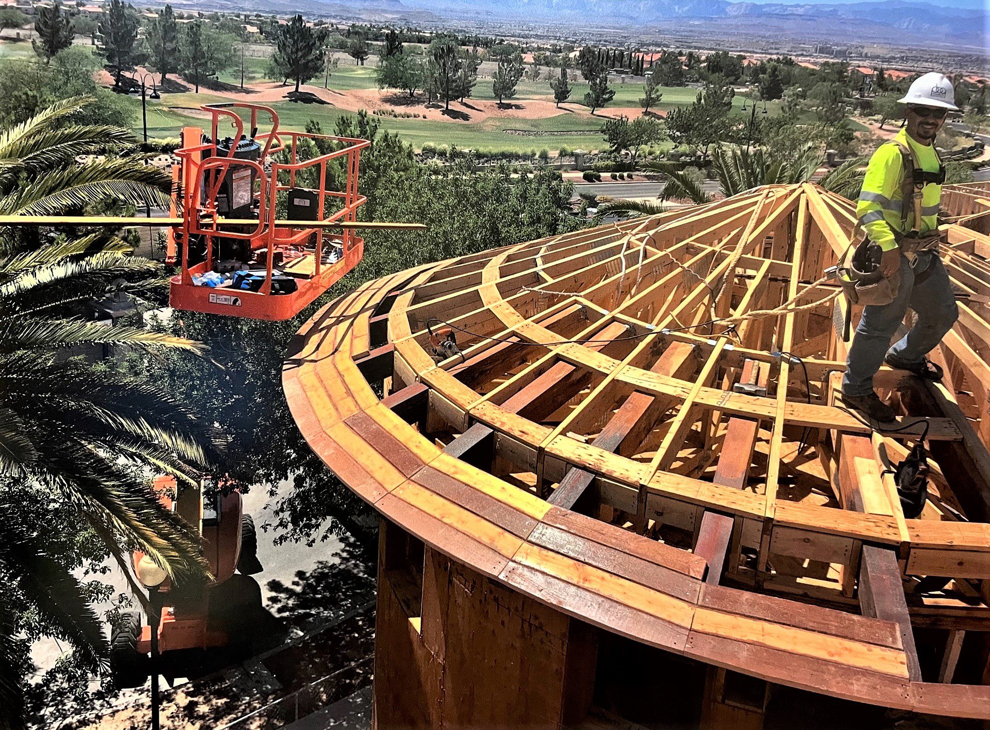 A worker is working on the roof of a house.