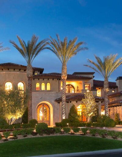 A beautiful mediterranean style home at night.