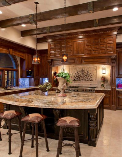 A large kitchen with marble counter tops and wooden cabinets.