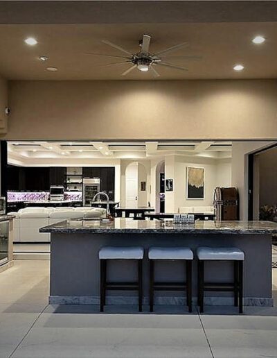 A kitchen with a large island and counter tops.