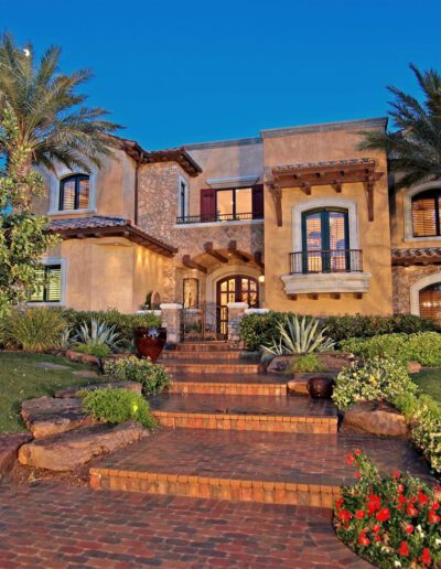 A beautiful home with a brick walkway and landscaping.