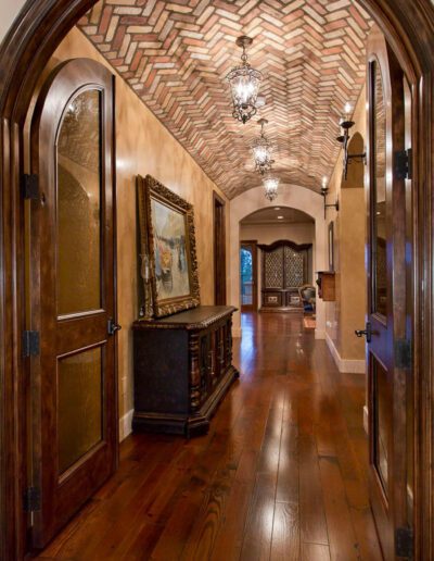 A hallway with wooden floors and an archway.