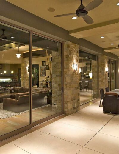 A living room with a fireplace and sliding glass doors.
