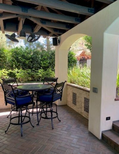 An outdoor patio with a table and chairs.