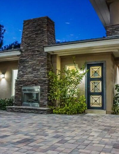 A home with a brick walkway at night.