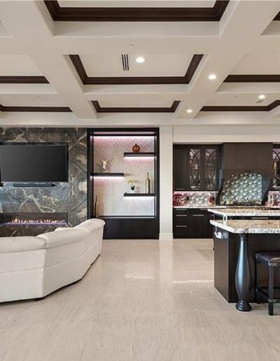 A large kitchen with a large island and a fireplace.