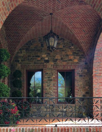 An arched entryway with wrought iron railings.