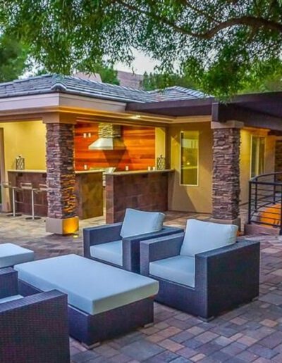A patio with outdoor furniture and a fireplace.