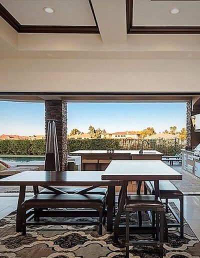 A large living room with a fireplace and sliding glass doors.