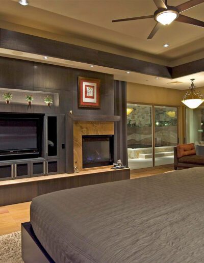 A bed in a bedroom with a fireplace.