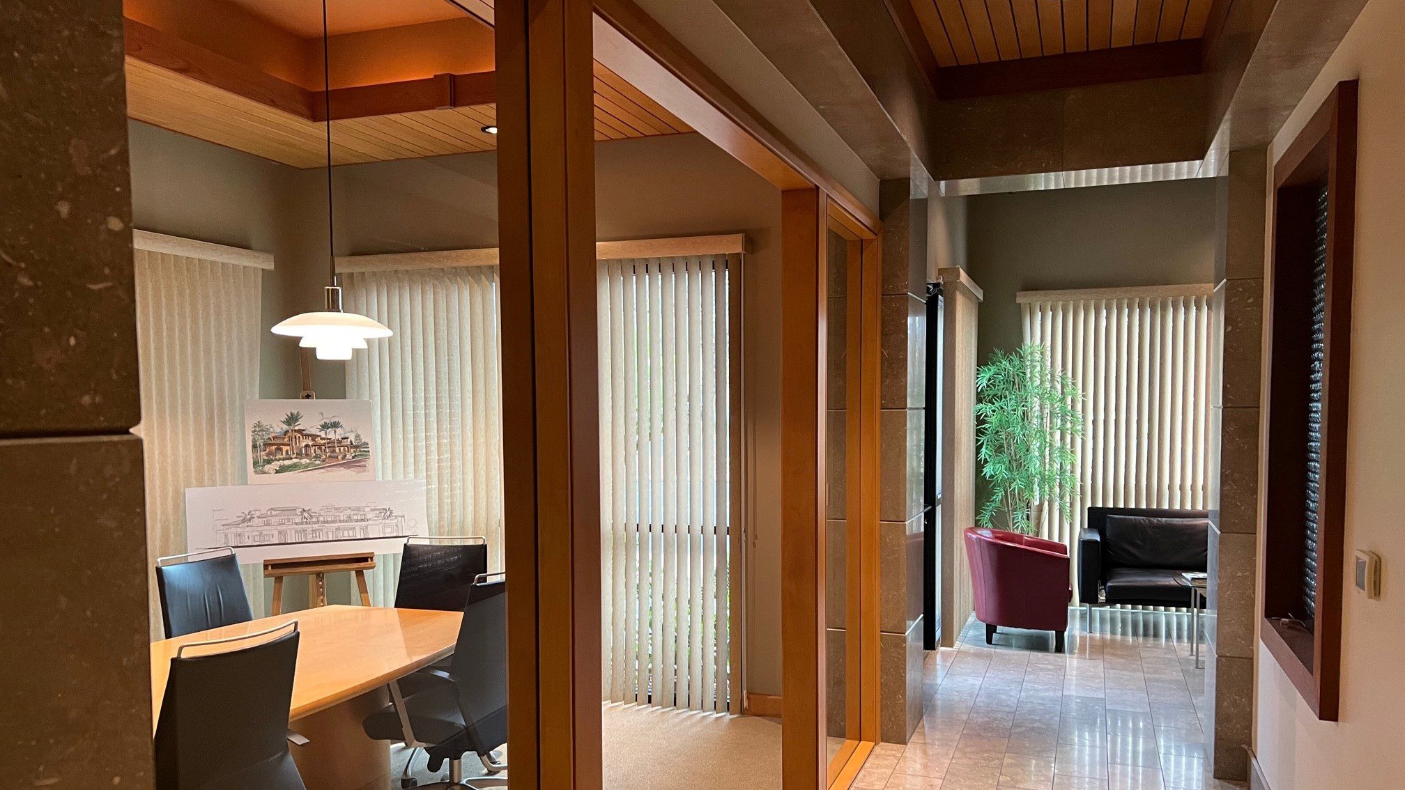 A hallway with a wooden table and chairs.