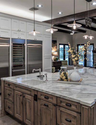 A large kitchen with marble counter tops and hardwood floors.