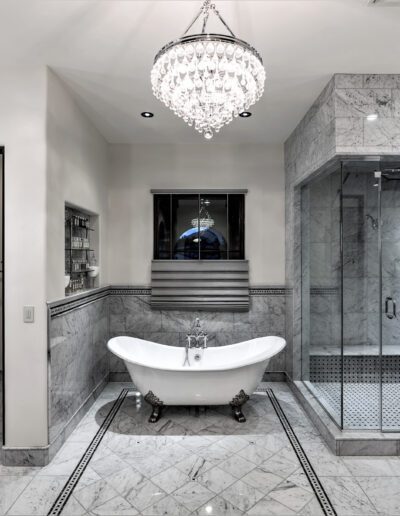 A bathroom with a large tub and a chandelier.