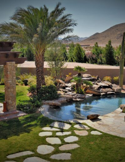 A backyard with a pool and landscaping.